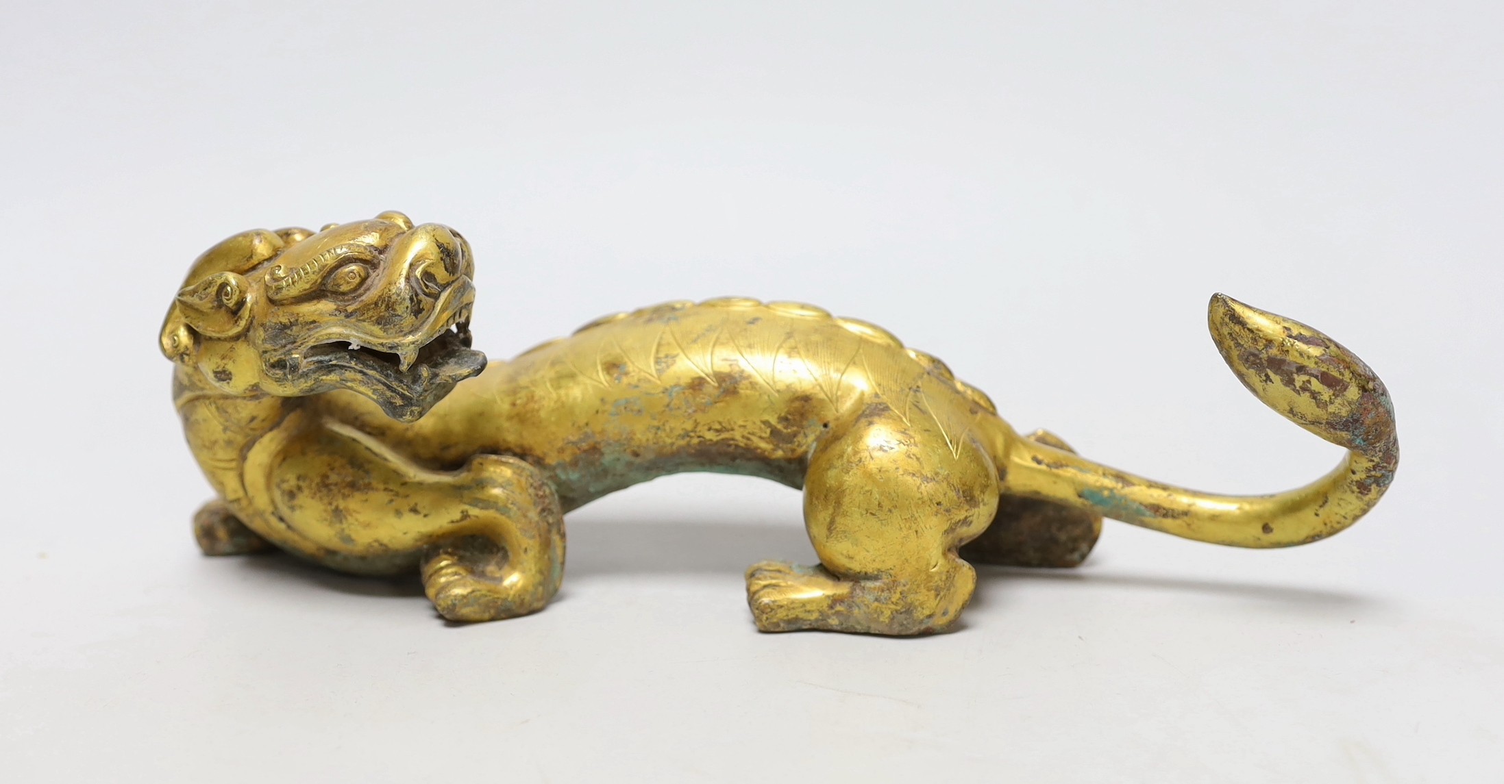 A Chinese gilt bronze figure of a dragon, Han or later, 25cm wide